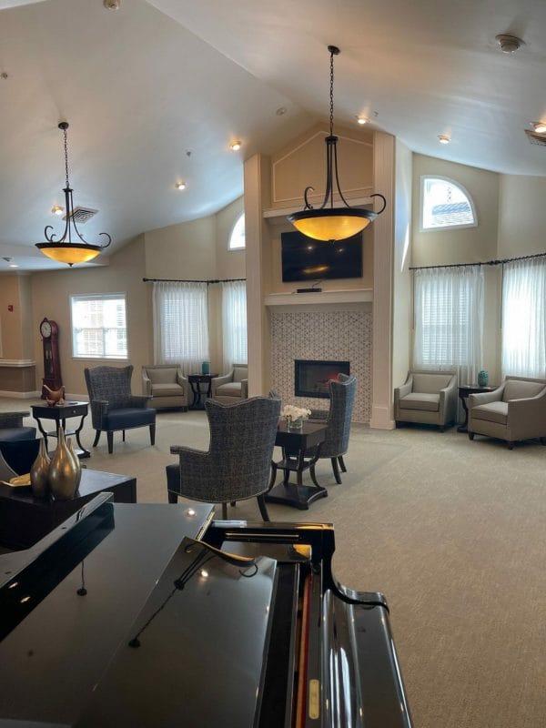 Baby grand piano and commuity seating in Charter Senior Living of Orland Park