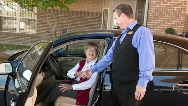 Valet at Lake Howard Heights assisting senior woman from her car