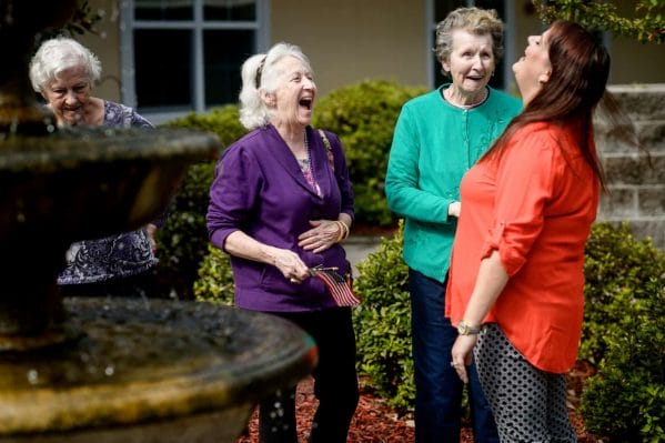 Women laughing by the fountain at The Beacon at Gulf Breeze
