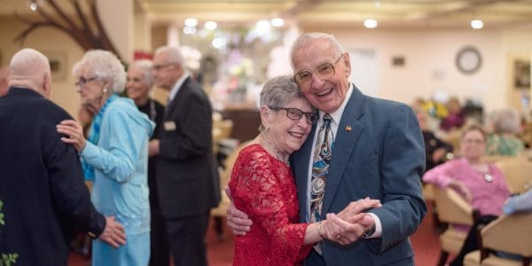 Eldery couple dancing and smiling at Maple Ridge Retirement