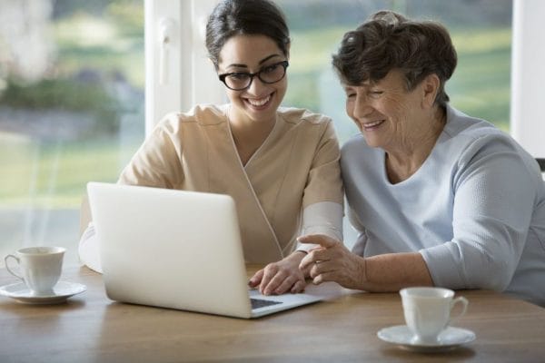 Young woman and senior woman using a laptop computer