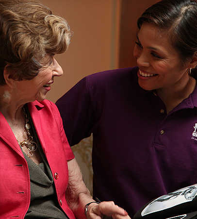 Home Instead Senior Care - Columbia female caregiver talking with senior woman