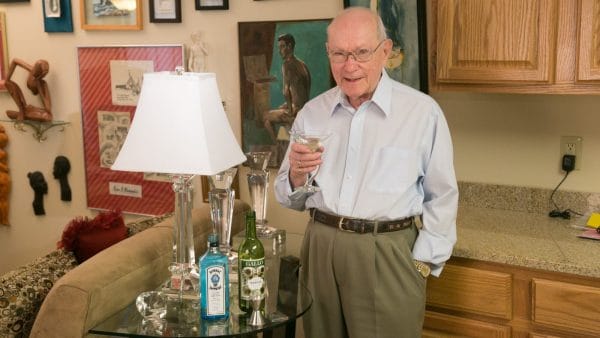 Elderly gentleman having a gin cocktail at Riverstone Retirement
