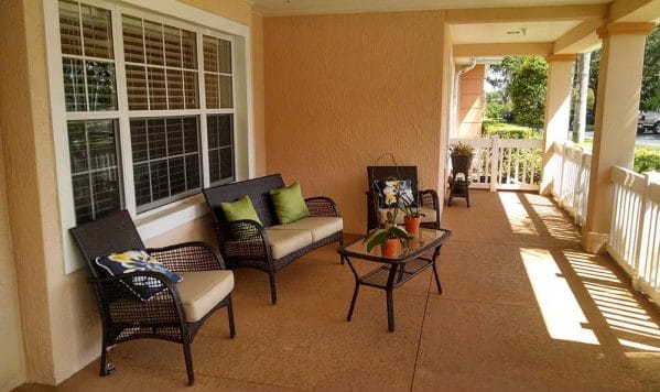 Resident porch at Savannah Cottage of Lakeland with loveseat and chairs