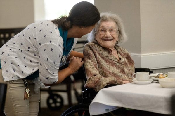 The Beacon at Gulf Breeze resident smiling at caregiver
