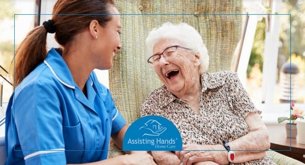 Senior woman laughing with Assisting Hands - Richmond caregiver
