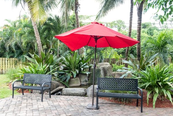 Outdoor benches and umbrellas at Jupiter Rehabilitation and Healthcare Center