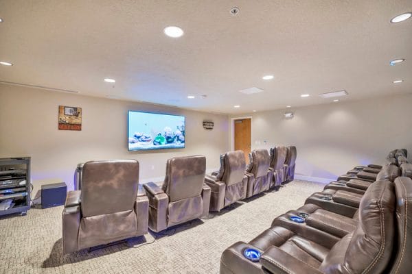 Crescent Senior Living resident movie theater with overstuffed recliner chairs