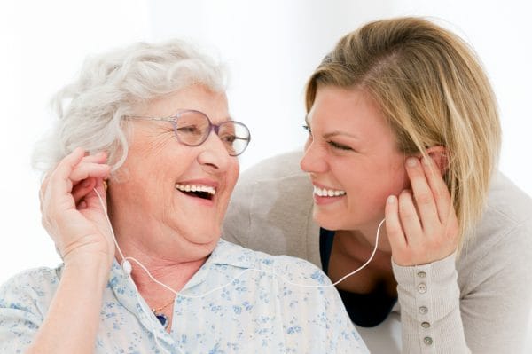Enjoying music with a senior as a home health caregiver
