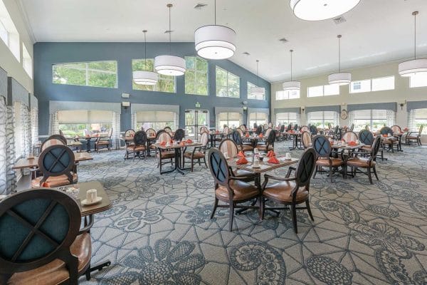 Community dining room with large windows in The Colonnade at Beckett Lake