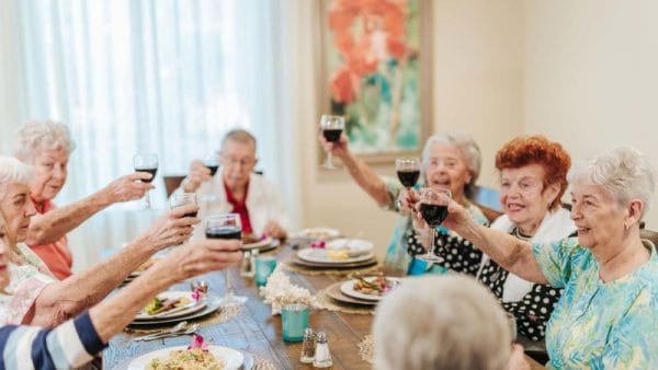 seniors toasting in celebration at dinner