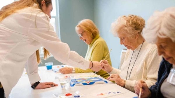 senior women painting during an activity