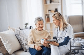Female VIP Homecare Solutions caregiver reviewing medication with senior woman