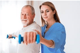 Senior man lifting hand weight with help from a VIP Homecare Solutions caregiver