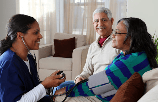 Senior couple having vitals checked by VIP Homecare Solutions caregiver