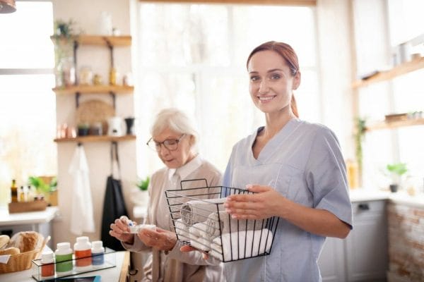Compassionate Care female caregiver organizing senior womans towels
