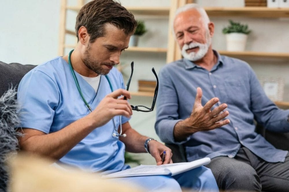 Senior man with beard getting tested for prostate cancer talking with male medical professional