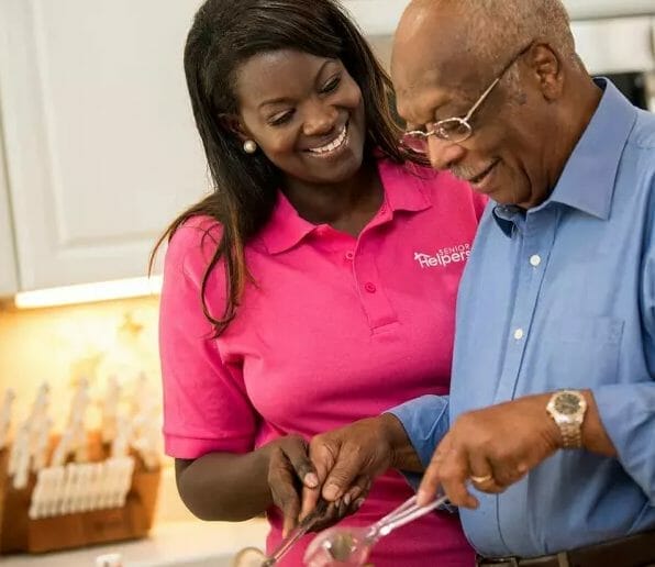 Senior Helpers caregiver helping senior man in the kitchen
