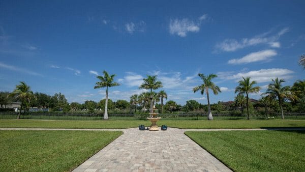 Outdoor paved walkway with a teired water fountain on the grounds of Seaside at Fort Myers