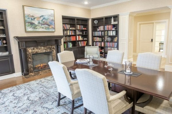 Private dining room with a fireplace and book lined walls in Ashleigh at Lansdowne