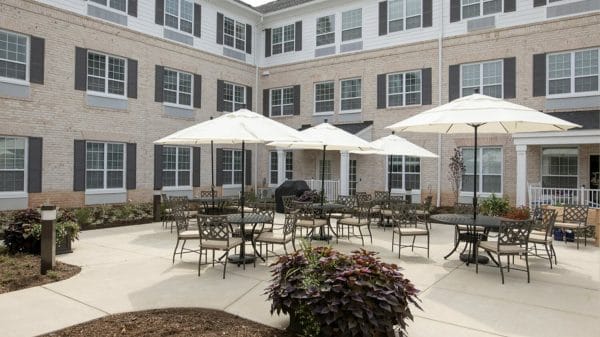 Umbrella tables in the The Wellington at Lake Manassas courtyard