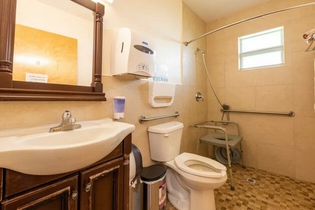 Model home bathroom with a walk in shower in Sunny Days Assisted Living