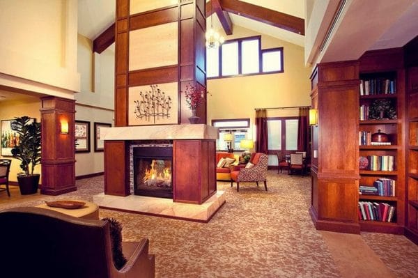 Community living room and fireside seating area in MorningStar Memory Care at Bear Creek