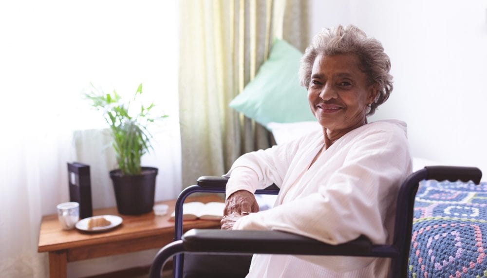 senior woman in a chair smiling
